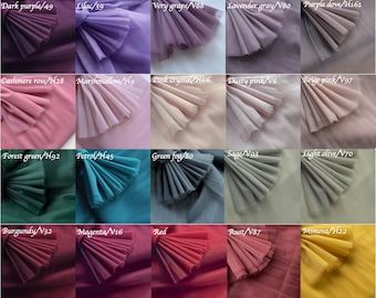 May include: A color chart showcasing a variety of fabric swatches in a range of colors, including white, ivory, cream, beige, and peach. Other colors include dark purple, lilac, very grape, and lavender gray. The swatches are arranged in rows and columns.