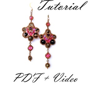 May include: A pair of long, dangling earrings with a floral design. The earrings are made with brown, black, and pink beads. The earrings are hanging from a silver hook.