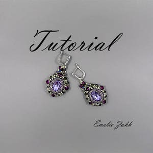 May include: A pair of purple and silver beaded earrings with a teardrop-shaped crystal in the center. The earrings are hanging from silver hooks. The word "Tutorial" is written in black cursive above the earrings. The text "Emelie Zakk" is written in black cursive below the earrings.