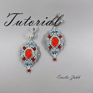 May include: A pair of silver earrings with red and blue beads, featuring a teardrop-shaped red gemstone in the center of each earring. The earrings are intricate and detailed, with a delicate design.