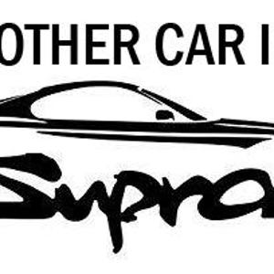 May include: A black and white decal featuring the text MY OTHER CAR IS A in a bold sans-serif font above a stylized silhouette of a sports car. The word Supra is written in a large, flowing script font underneath the car outline.