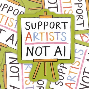 May include: A sticker with the words "SUPPORT ARTISTS NOT AI" on a white background, framed in green, and set on a wooden easel. The word "ARTISTS" is in colourful letters. Other stickers with the same design are in the background.