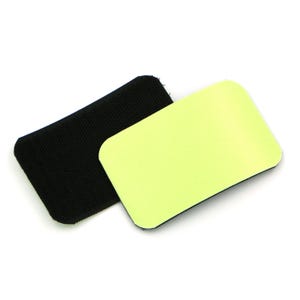 May include: A pair of black hook and loop fasteners, one with a soft, fuzzy surface and the other with a smooth, light green surface.