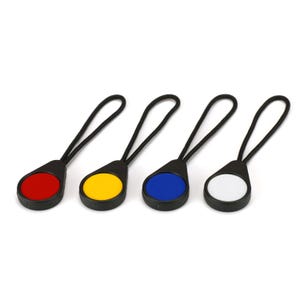 May include: Four zipper pulls with different coloured round buttons. The buttons are red, yellow, blue, and white.