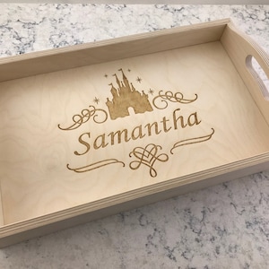 May include: A light wood serving tray with a laser-engraved design of a castle and the name "Samantha".