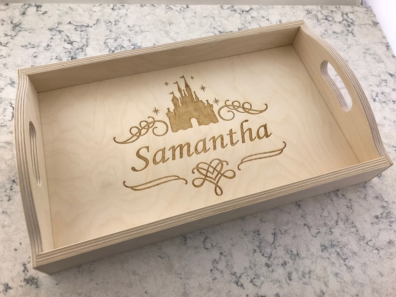 May include: A light wood serving tray with a laser-engraved design of a castle and the name "Samantha".