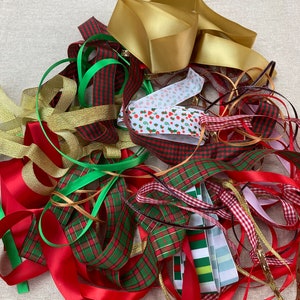 May include: A pile of colourful ribbon scraps in red, green, gold, and white with plaid, polka dot, and striped patterns.