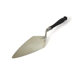 May include: A silver trowel with a black wooden handle. The trowel is a tool used for spreading mortar or plaster.