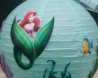 The Little Mermaid centerpiece with Ariel Sebastian and Flounder and sparkling sea plants and colorful seafloor foot for under the sea party