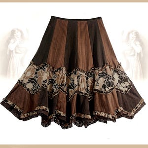 May include: A brown and tan tiered skirt with floral print and lace trim.