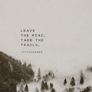 May include: A black and white inspirational quote against a foggy forest backdrop. The quote reads "Leave the road, take the trails." - Pythagoras.