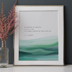 May include: Framed art print with a quote by E.E. Cummings, featuring a watercolor design in shades of green and blue. The quote reads, "For whatever we lose (like a you or a me) it's always ourselves we find in the sea."