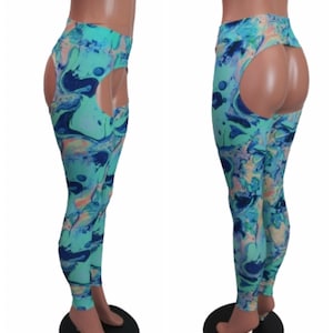 May include: A pair of leggings with a unique design, featuring a high waist and cut-out detailing. The leggings showcase a vibrant pattern of swirling blues, greens, and peach tones. The leggings are displayed on a mannequin.