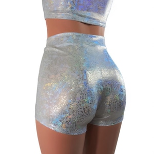 May include: Silver iridescent shorts with a high waist and a short length. The shorts have a textured, scaly pattern.
