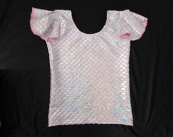 May include: A pink iridescent mermaid-scale fabric top with short sleeves and a scoop neck.