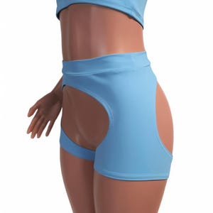 May include: Light blue shorts with a cut-out detail on the back. The shorts have a high waist and a fitted silhouette.