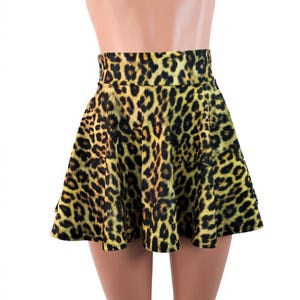May include: A yellow and black leopard print skater skirt.