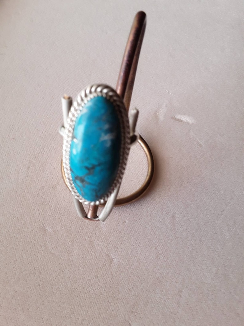 Large oval turquoise ring.