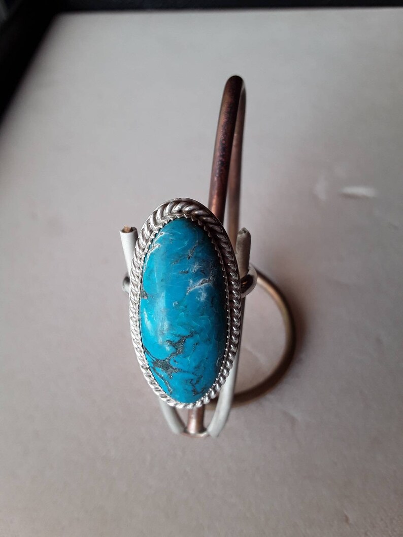 Large oval turquoise ring.