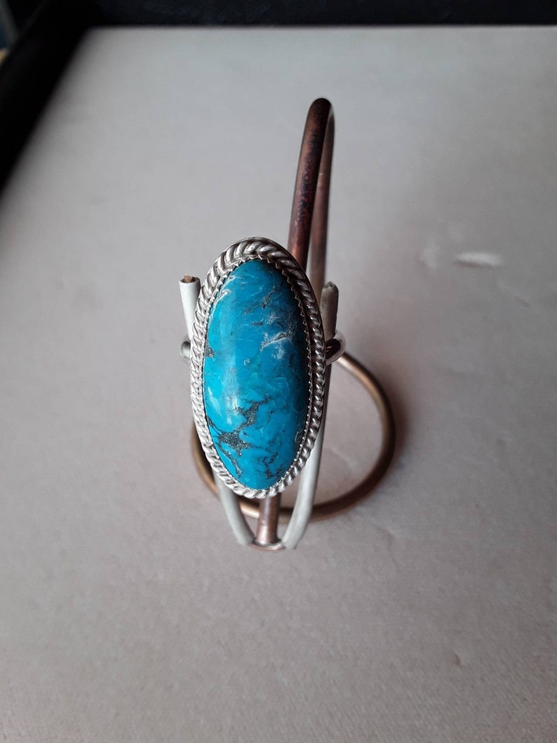 Large oval turquoise ring.