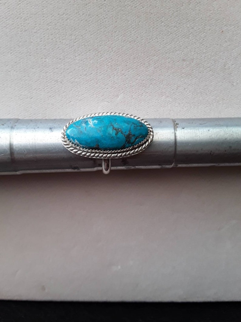 Large oval turquoise ring.