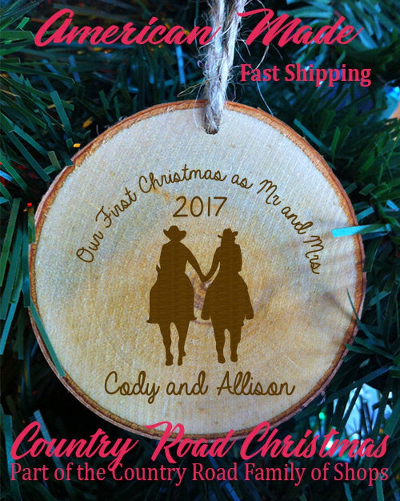 May include: A wooden Christmas ornament with the text "Our First Christmas as Mr and Mrs 2017 Cody and Allison" and a silhouette of a couple riding horses.