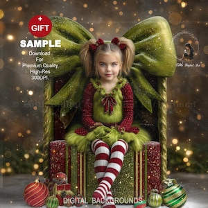 May include: A young girl in a festive green and red outfit sits on a large gift box with a green bow. The box is decorated with red and gold stripes. Christmas ornaments are scattered around the base of the box. The image includes the text "GIFT" and "SAMPLE".