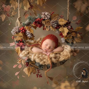 May include: A sleeping newborn baby wearing a red knitted hat is nestled in a cream-coloured woven basket. The basket is hanging from a rope and is surrounded by a wreath of autumn leaves, pine cones, and red berries.