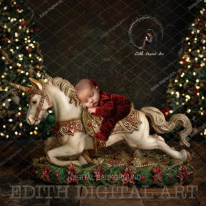 May include: A newborn baby in a red velvet outfit sleeps on a white unicorn rocking horse. The horse is decorated with gold accents and is surrounded by a green and red floral base. The background features two Christmas trees with twinkling lights.