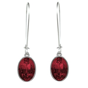 May include: A pair of silver dangle earrings with oval-shaped red gemstones.