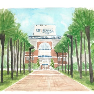 May include: Watercolor painting of a stadium entrance with a sign that reads "University of Florida, Ben Hill Griffin Stadium". The entrance is lined with palm trees and a brick walkway.