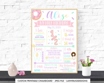 May include: A pink and brown chalkboard style sign with a donut graphic and the text "Alize My Half Birthday! May 20, 2022". The sign lists facts about the child, including their weight, height, likes, dislikes, and abilities.