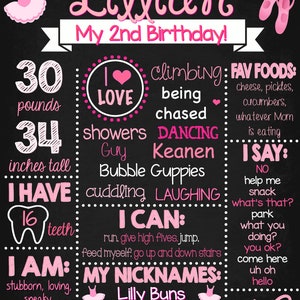 May include: A pink and black chalkboard sign with the text "Lillian My 2nd Birthday!"  The sign lists facts about the child, including their weight (30 pounds), height (34 inches), favorite foods, and things they can do. The sign also includes a drawing of a ballerina.