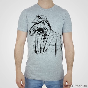 May include: A gray t-shirt with a black and white illustration of a horse wearing a suit and a hat.