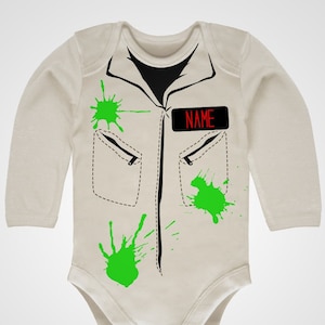 May include: A white baby onesie with a black and white illustration of a jumpsuit with green paint splatters and a red name tag that says "NAME".