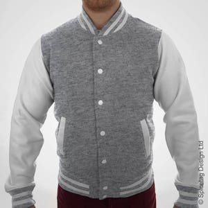 May include: A gray and white varsity jacket with a button closure and white sleeves. The jacket has a ribbed collar, cuffs, and waistband.