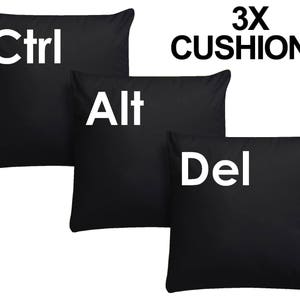 May include: Three black throw pillows with white text. The pillows read "Ctrl", "Alt", and "Del".
