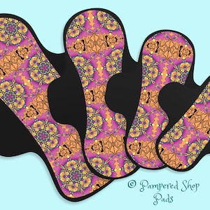 May include: Three reusable cloth menstrual pads with a colorful floral pattern in shades of pink, orange, yellow, and blue. The pads are made of soft, absorbent fabric and are designed to be comfortable and discreet. © Pampered Shop Pads
