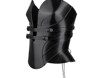 May include: A black structured corset top featuring a smooth finish, curved panels, and two horizontal straps with metal buckles across the front opening. The garment has a high, rounded neckline and thin laces hanging from the bottom hem.