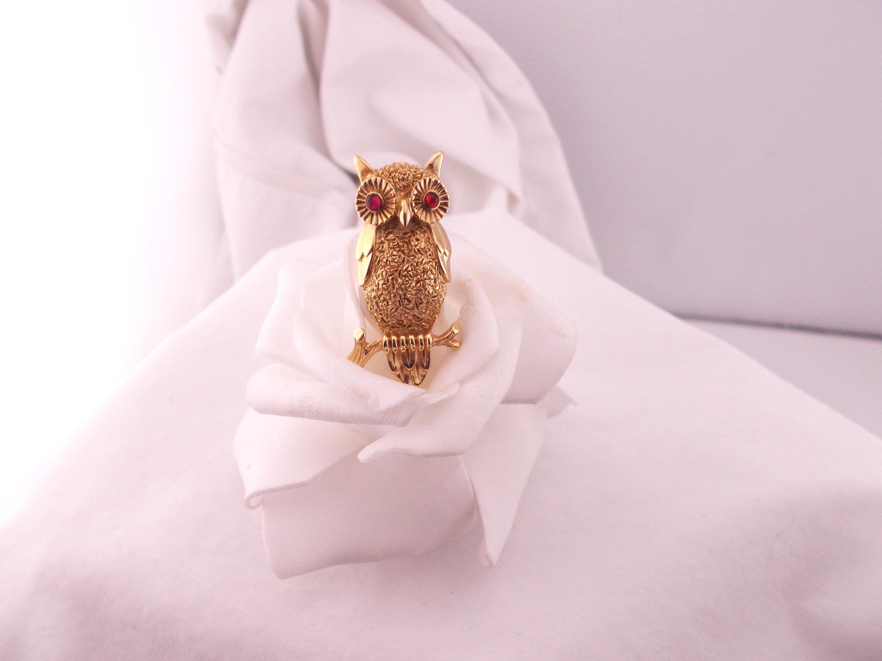 Crown Trifari vintage gold tone owl perched on a branch brooch, ruby red glass eyes