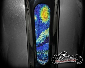 May include: A black motorcycle fender with a custom paint job featuring a reproduction of Vincent van Gogh's "Starry Night" painting. The painting is in a vertical rectangular shape and is centered on the fender.