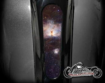 May include: A black motorcycle gas tank with a custom decal featuring a nebula in space. The decal is in a vertical rectangular shape and is located on the front of the tank. The text "AMERICAN FREEDOM" is visible at the bottom of the image.