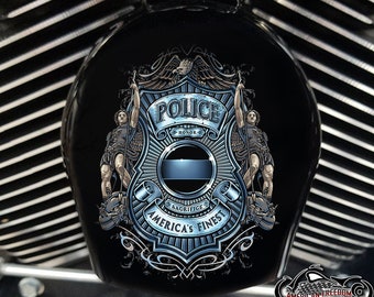 May include: A blue and silver police badge with a thin blue line, surrounded by an eagle and two figures holding swords. The badge says "Police" and "Honor" and "America's Finest" with a banner that says "Sacrifice".