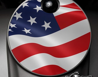 May include: A round, red, white, and blue American flag gas cap decal. The flag is waving in the wind.