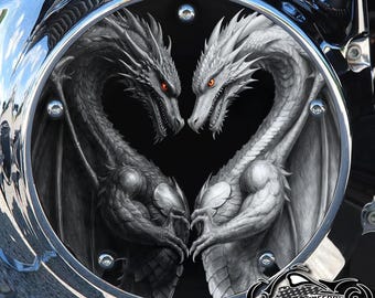 May include: A motorcycle part with a detailed illustration of two dragons facing each other, forming a heart shape. One dragon is black, the other is white, both with red eyes. The image is set within a chrome frame, with the "American Freedom" logo at the bottom.