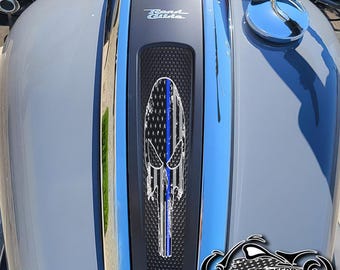 May include: A close-up of a motorcycle gas tank with a black and blue skull graphic with an American flag design. The text "Road Glide" is visible on the tank. The text "AMERICAN FREEDOM" is visible at the bottom of the image.