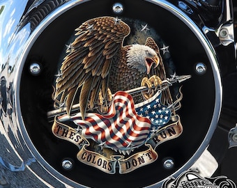 May include: A black motorcycle cover with a bald eagle holding an American flag and a spear. The eagle is perched on a banner that reads "These Colors Don't Run".