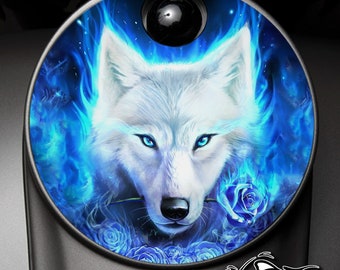 May include: A white wolf with blue eyes is surrounded by blue flames and blue roses. The wolf is looking directly at the viewer. The image is circular and has a black background.