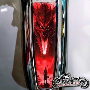 May include: A motorcycle gas tank with a red dragon graphic. The dragon's head is centered, with a warrior figure at the bottom. The tank has a chrome finish and the words "American Freedom" are visible.