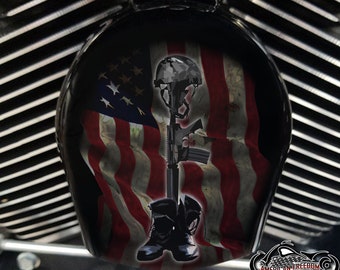 May include: A black and white image of a fallen soldier memorial. The image features a helmet, rifle, and boots against a backdrop of an American flag.